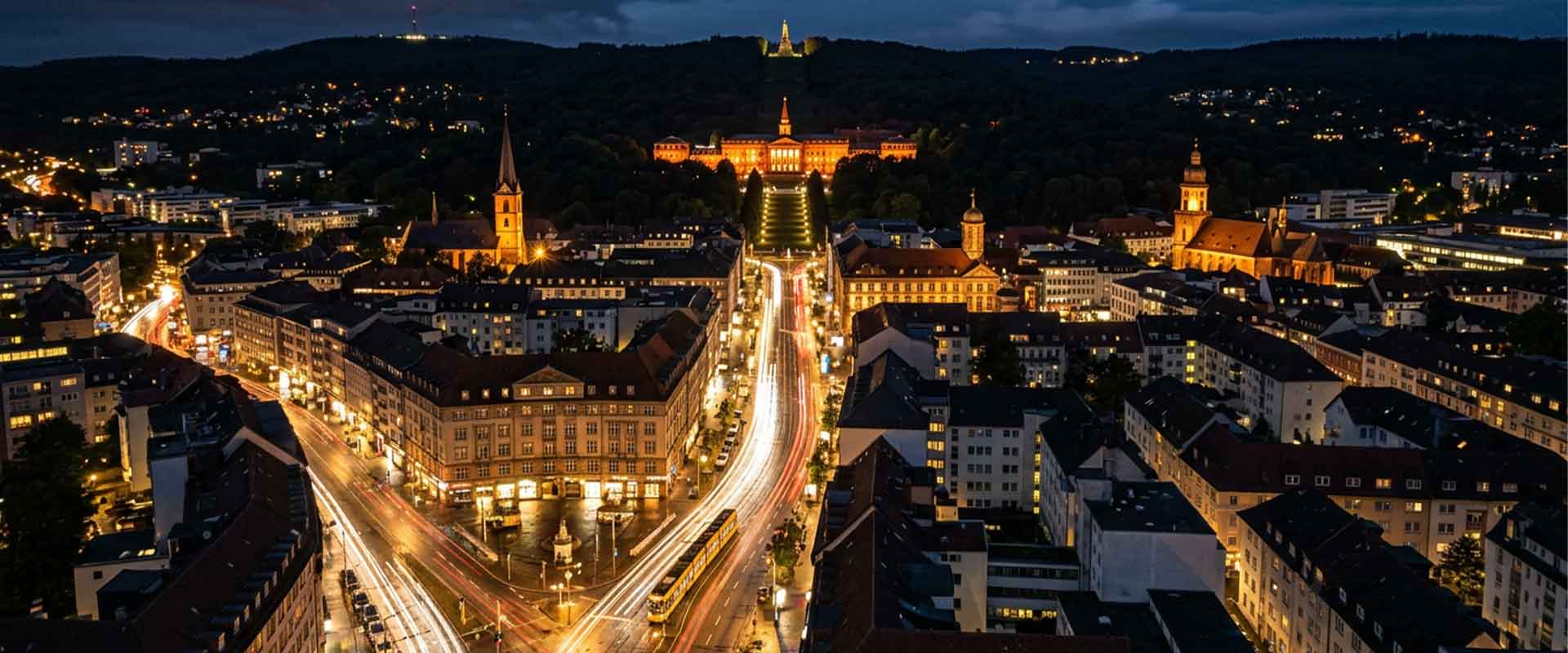 View of a lit city at night with historic buildings and streets, ideal for escort service advertising.