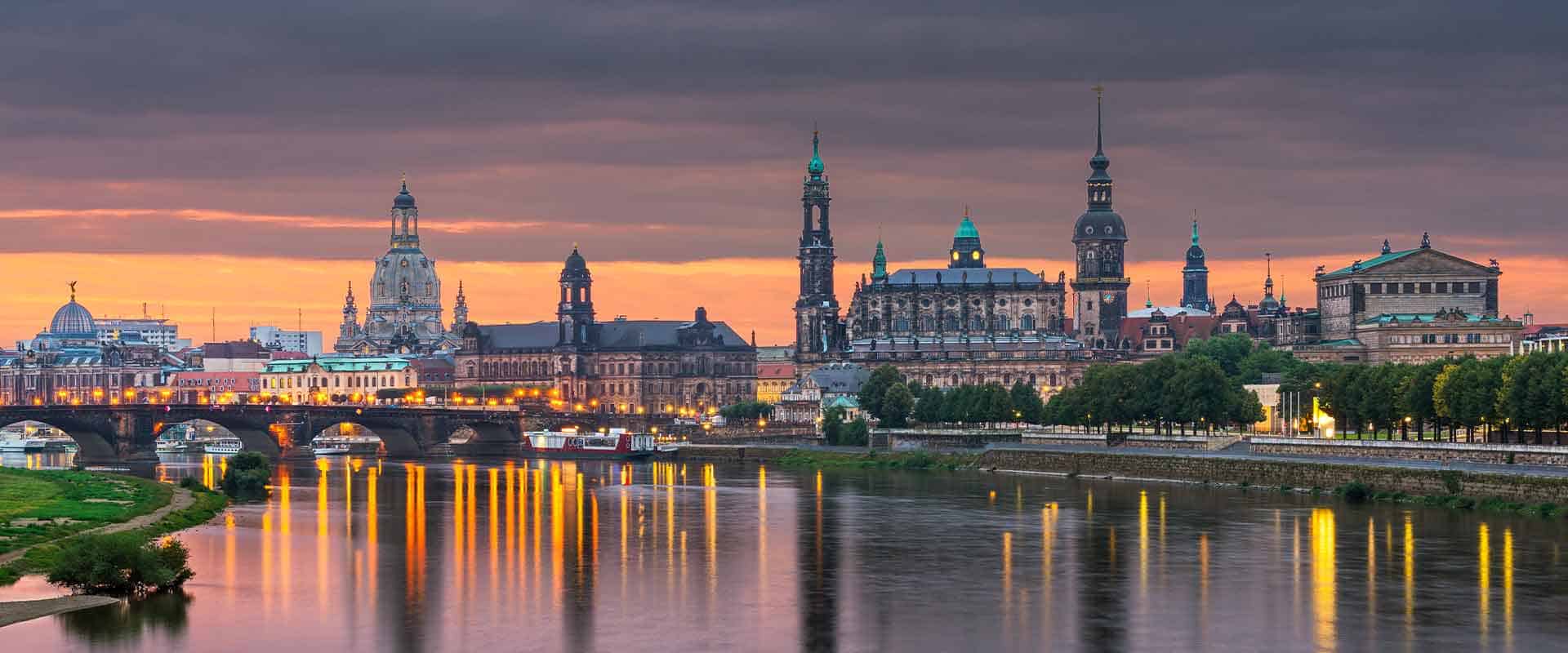 Panoramic shot of the Dresden skyline at sunset, with a view of the Elbe river and historic buildings, ideal for an escort service website.