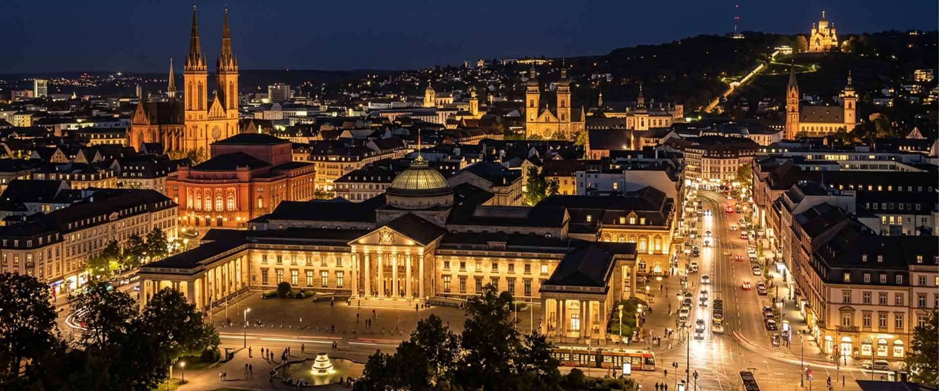 View of the illuminated city center at night with historic buildings and streets in a European city, ideal for escort service advertising.