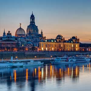 City view at sunset with historic city center and water reflection, ideal for a perfect escort service experience in Berlin.