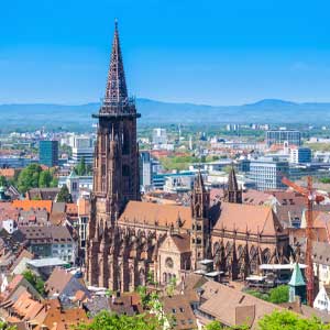 Old: View of a historic church in the city, with an urban skyline in the background, suitable for an escort service website.